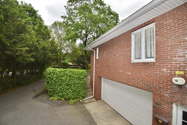 166 Primrose Dr, Longmeadow, MA 01106 - view of side of home with a garage and brick siding