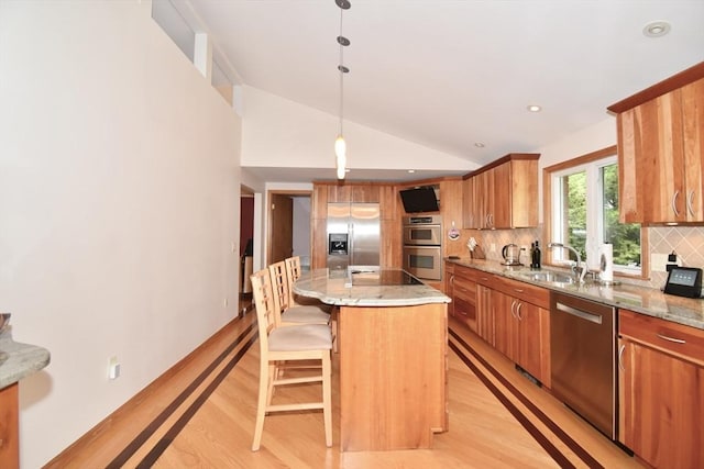 166 Primrose Dr, Longmeadow, MA 01106 - kitchen with appliances with stainless steel finishes, light wood-type flooring, lofted ceiling, backsplash, and a breakfast bar
