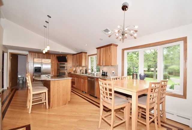 166 Primrose Dr, Longmeadow, MA 01106 - dining area featuring vaulted ceiling, a chandelier, baseboard heating, light wood-style floors, and plenty of natural light