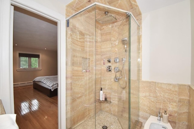 166 Primrose Dr, Longmeadow, MA 01106 - full bath featuring a baseboard heating unit, a bidet, a shower stall, wood finished floors, and tile walls