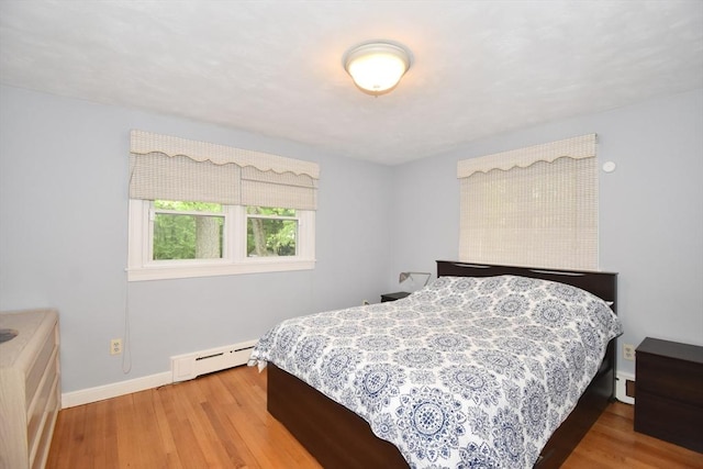 166 Primrose Dr, Longmeadow, MA 01106 - bedroom with a baseboard heating unit, wood finished floors, and baseboards