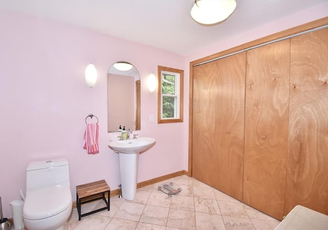 166 Primrose Dr, Longmeadow, MA 01106 - bathroom with toilet, a sink, and baseboards