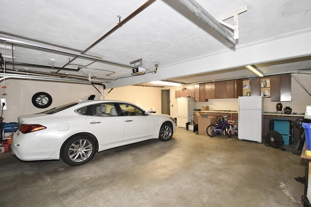 166 Primrose Dr, Longmeadow, MA 01106 - garage with freestanding refrigerator and a garage door opener