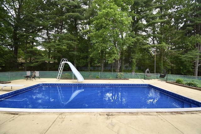 166 Primrose Dr, Longmeadow, MA 01106 - view of pool with a water slide, a diving board, view of scattered trees, and a patio