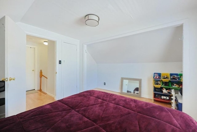 bedroom featuring vaulted ceiling and wood finished floors