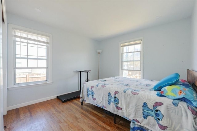bedroom featuring wood-type flooring and baseboards