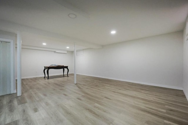 finished below grade area featuring baseboards, wood finished floors, and recessed lighting