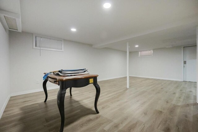 finished basement with baseboards, wood finished floors, and recessed lighting