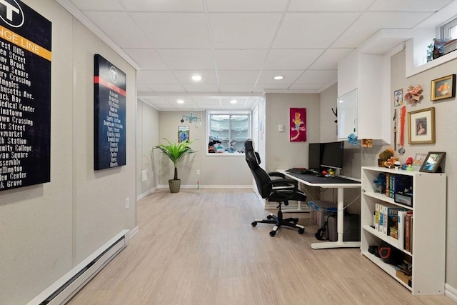 office with baseboards, light wood-style floors, recessed lighting, a drop ceiling, and a baseboard heating unit