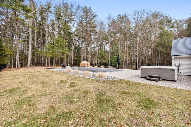 view of yard with a patio area, fence, and a hot tub