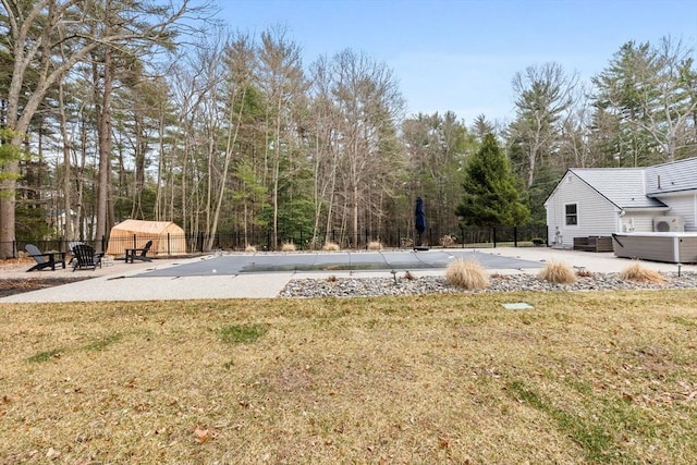 view of yard with a fenced in pool, a patio, and fence