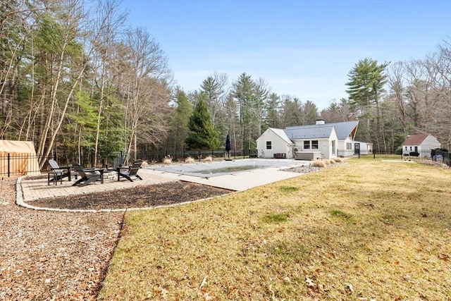 view of yard featuring a patio area, a fenced in pool, and fence