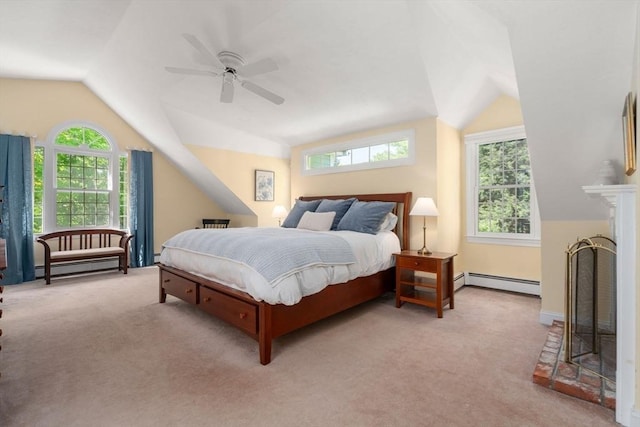 bedroom featuring a baseboard heating unit, lofted ceiling, light colored carpet, and multiple windows