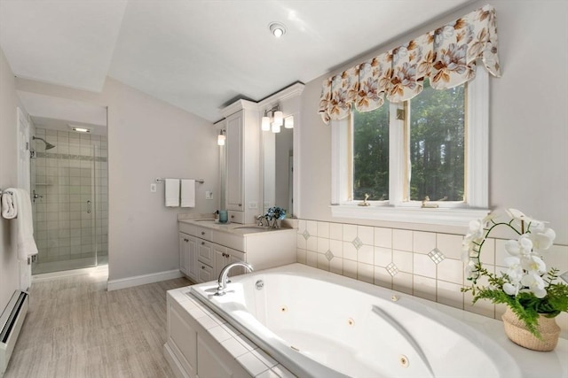 full bathroom featuring a baseboard radiator, a stall shower, a tub with jets, wood finished floors, and baseboards