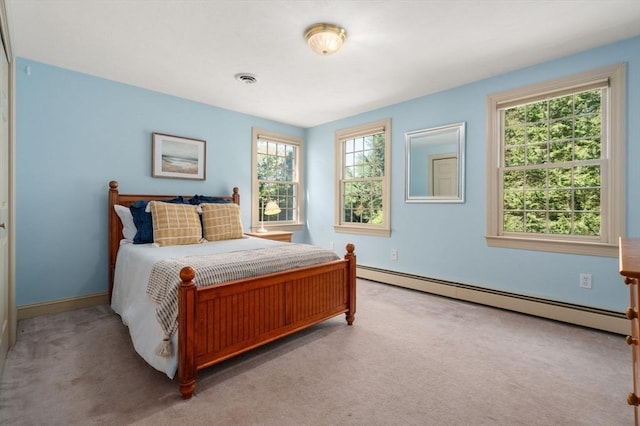 bedroom featuring a baseboard radiator, light colored carpet, and baseboards