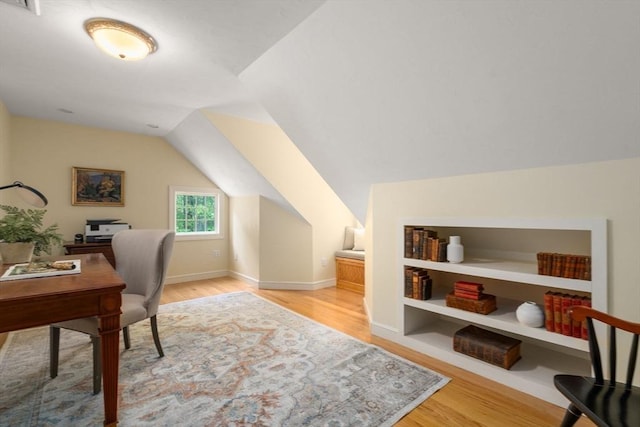 office space with wood finished floors, lofted ceiling, and baseboards