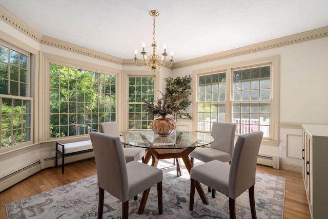 dining area featuring a chandelier, light wood-style floors, and baseboard heating