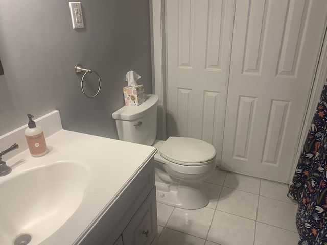 bathroom featuring vanity, tile patterned floors, and toilet