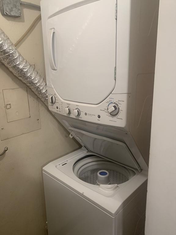 clothes washing area with laundry area and stacked washer / drying machine