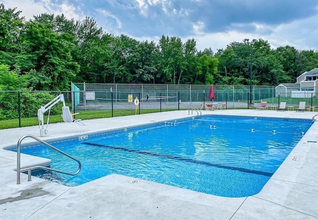 pool featuring a patio and fence