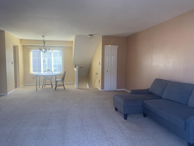 carpeted living room featuring an inviting chandelier and baseboards