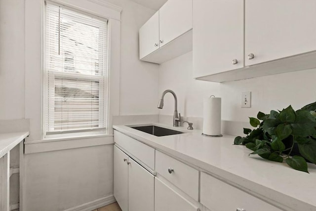 kitchen featuring sink and white cabinets