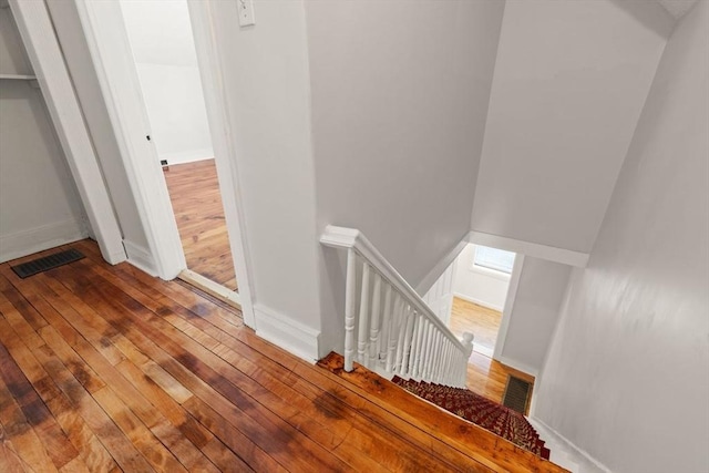 stairway featuring wood-type flooring