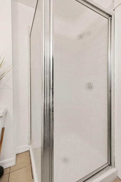 bathroom with tile patterned floors and walk in shower