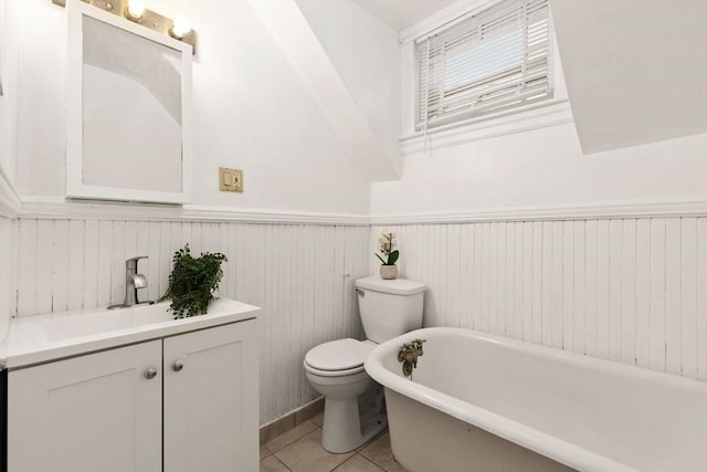 bathroom featuring vanity, tile patterned floors, toilet, and a bathing tub