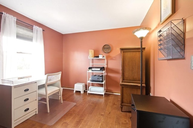 home office with baseboards and hardwood / wood-style floors