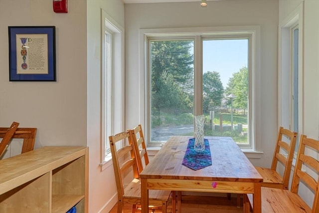 dining room featuring light wood-style floors and baseboards