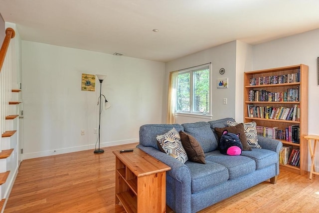 living room featuring light wood-type flooring and baseboards