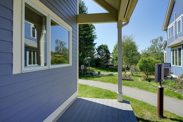 wooden terrace featuring a lawn