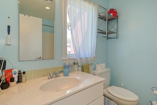 bathroom with toilet and vanity