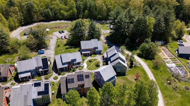 aerial view of property's location with a forest and nearby suburban area