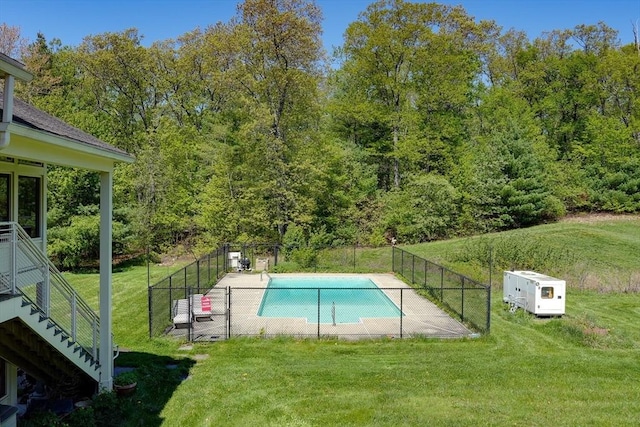 view of pool with a forest view