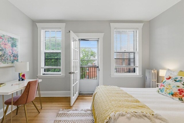 72 Strathmore Rd Unit 10B, Boston, MA 02135 - bedroom with wood finished floors, access to exterior, baseboards, radiator heating unit, and an office area