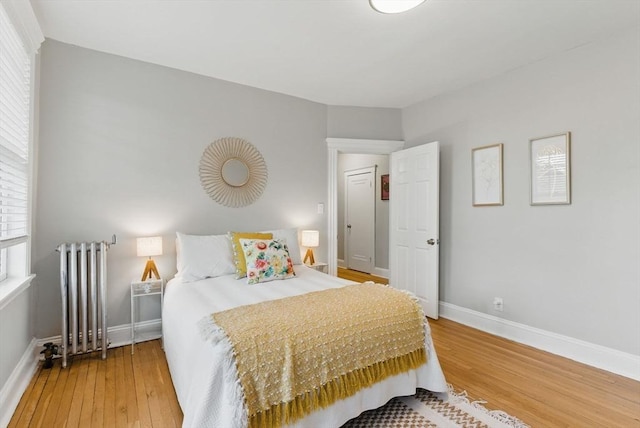 72 Strathmore Rd Unit 10B, Boston, MA 02135 - bedroom featuring radiator, wood finished floors, and baseboards