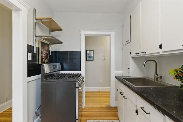 72 Strathmore Rd Unit 10B, Boston, MA 02135 - kitchen featuring stainless steel gas range, a sink, light wood-type flooring, white cabinets, and backsplash
