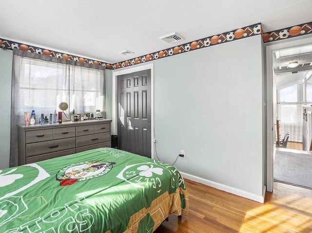 bedroom with a closet and hardwood / wood-style floors