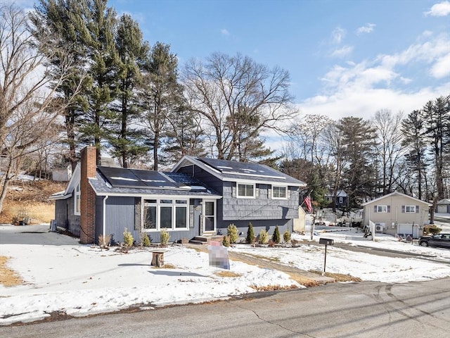 tri-level home featuring solar panels