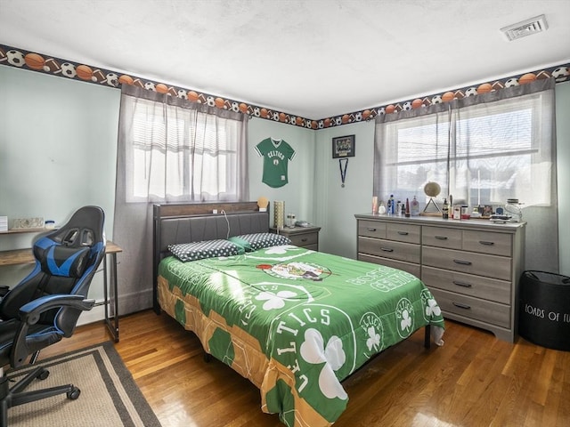 bedroom with hardwood / wood-style floors