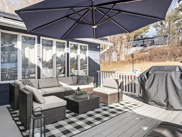 wooden deck featuring a grill and outdoor lounge area