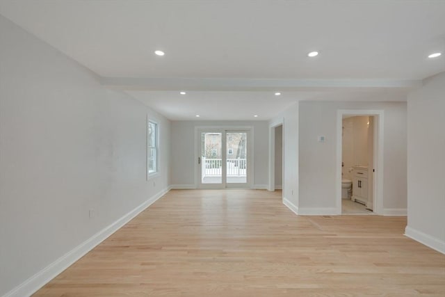 empty room featuring recessed lighting, light wood-type flooring, and baseboards