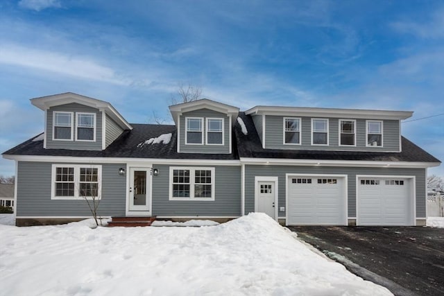 view of front of home with a shingled roof and an attached garage