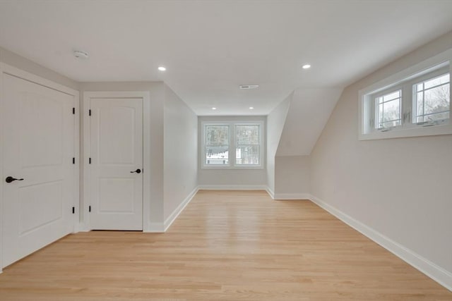 additional living space featuring recessed lighting, light wood-style flooring, and baseboards