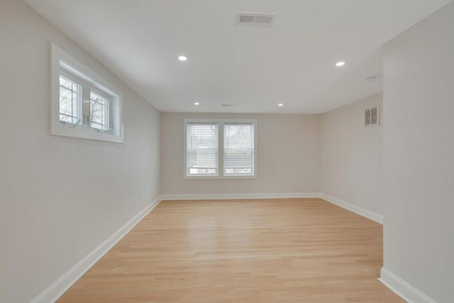 spare room with recessed lighting, light wood-type flooring, visible vents, and baseboards