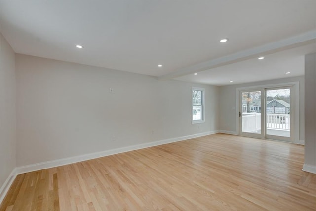 empty room featuring recessed lighting, light wood finished floors, and baseboards