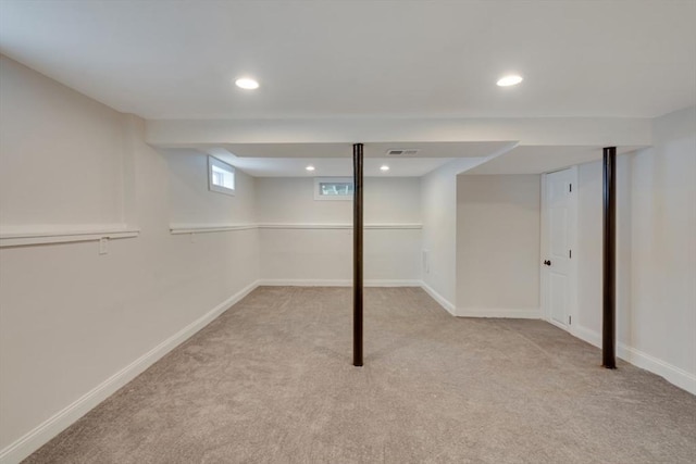 basement with recessed lighting, light carpet, and baseboards