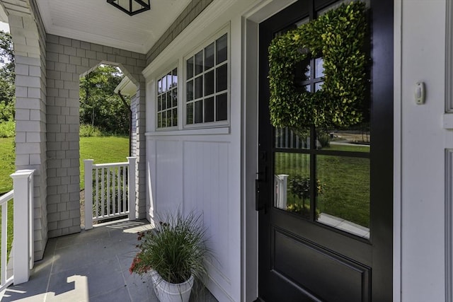 doorway to outside with crown molding and a healthy amount of sunlight